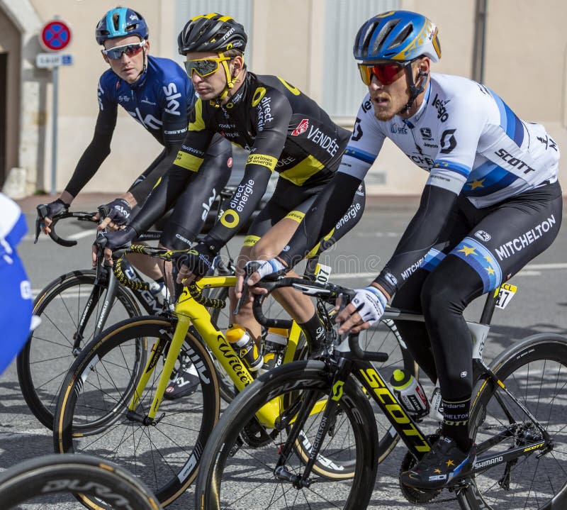 Chatillon-Coligny, France - March 10, 2019: Three cyclists Matteo Trentin of Mitchelton-Scott Team, Anthony Turgis of Direct Energie Team,Tao Geoghegan Hart of Team Sky riding in the peloton, in Chatillon-Coligny during the stage 3 of Paris-Nice 2019. Chatillon-Coligny, France - March 10, 2019: Three cyclists Matteo Trentin of Mitchelton-Scott Team, Anthony Turgis of Direct Energie Team,Tao Geoghegan Hart of Team Sky riding in the peloton, in Chatillon-Coligny during the stage 3 of Paris-Nice 2019